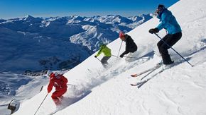 Les Menuires ski resort, skiers in powder snow